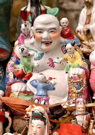 A collection of intricately painted ceramic figures, some with multiple figures attached, displayed on a surface. 4