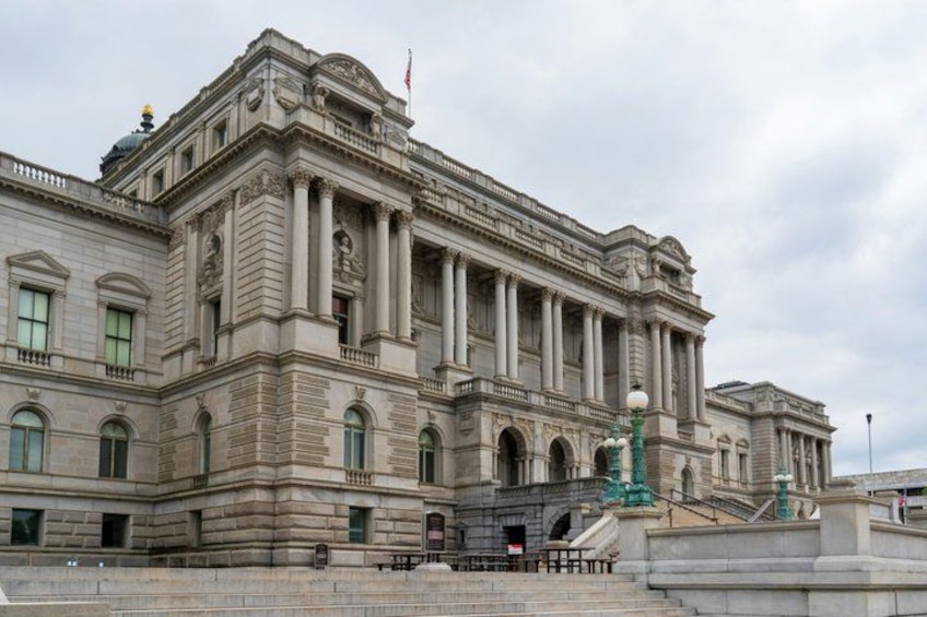 A large, historic building with classical architecture, featuring columns and a grand entrance. 4