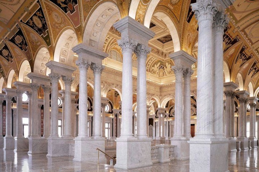 A grand hall with large white columns, arched ceilings, and intricate ceiling artwork. 5