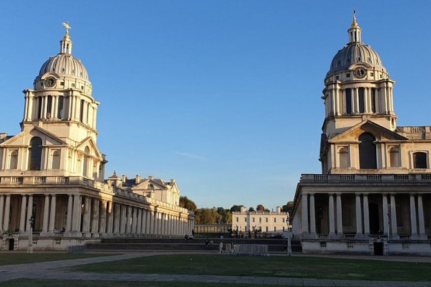 A large classical building with two domed structures and a symmetrical facade. 1