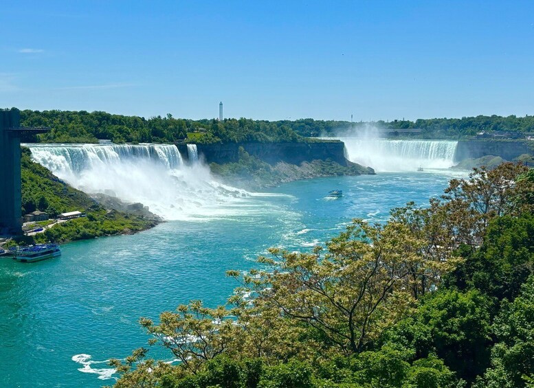 A large waterfall, a boat, and a forested area. 3