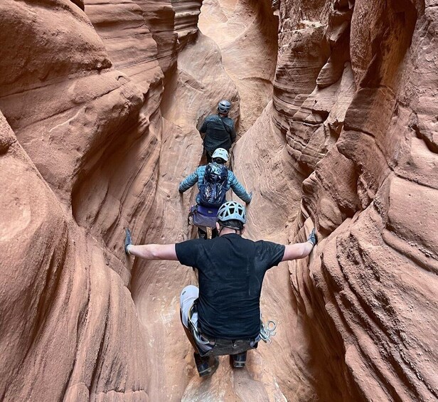 A person on a mountain bike navigating a narrow canyon with steep walls. 2