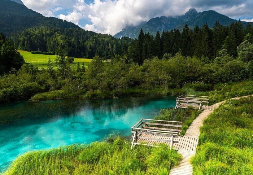 A clear mountain lake with a wooden walkway. 5