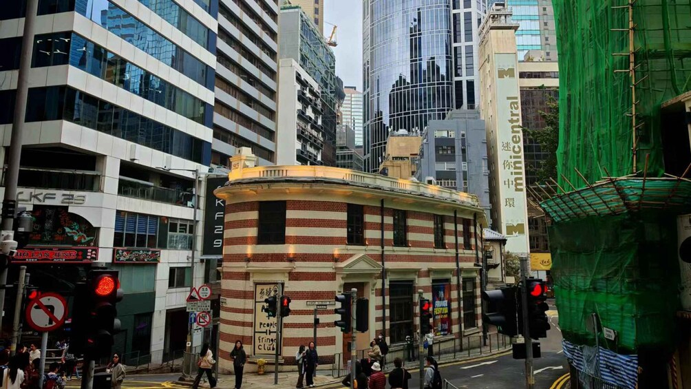 A busy urban street with pedestrians, traffic lights, and a mix of modern and traditional architecture. 2