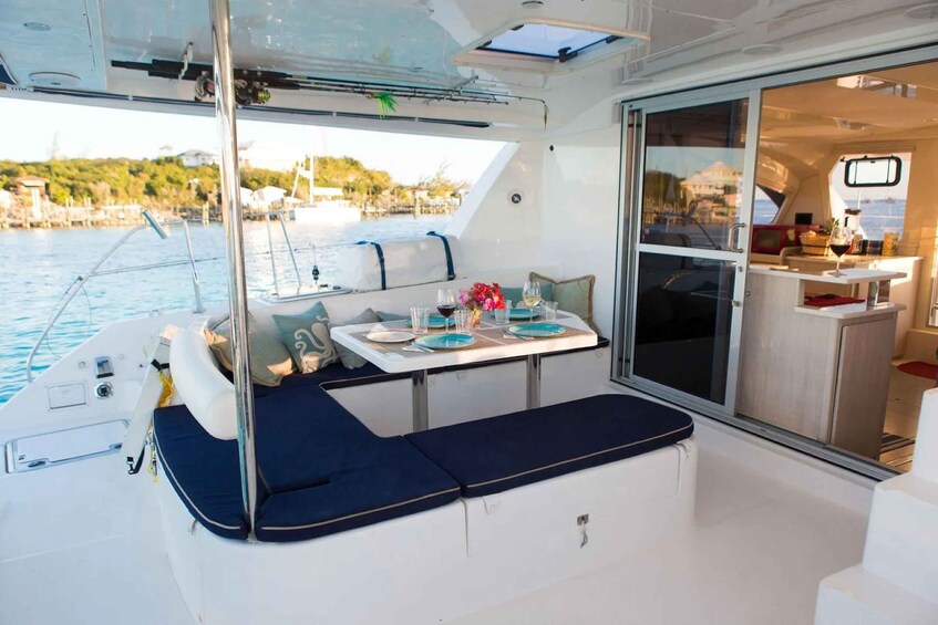A boat's interior with a dining area, a small kitchen, and a view of the water. 4