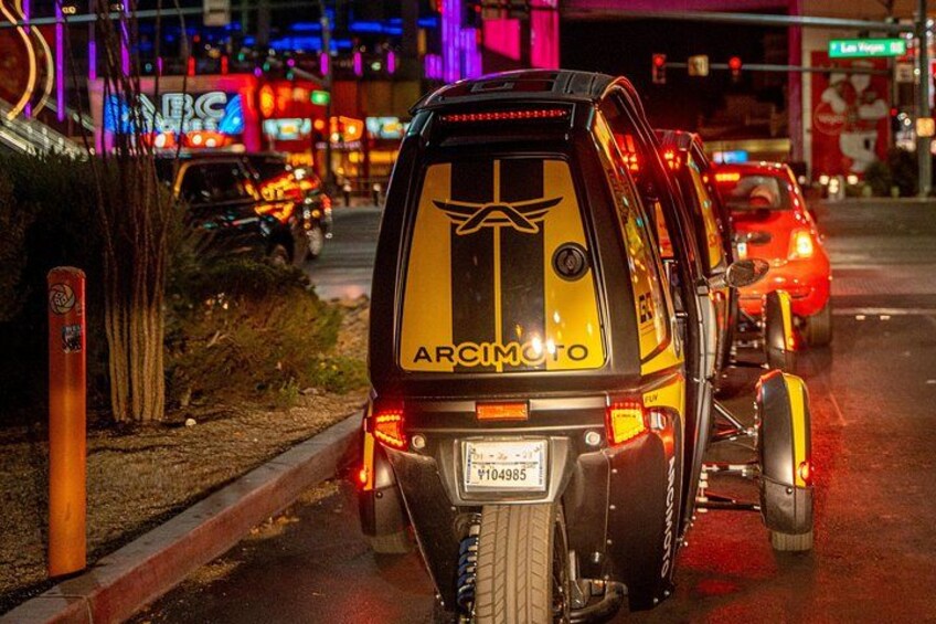 Una motocicleta con diseño amarillo y negro estacionada en una calle urbana de noche. 3