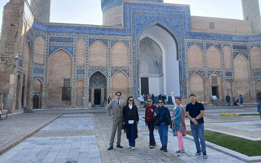 A historic building with intricate blue tile work and arched doorways. 1