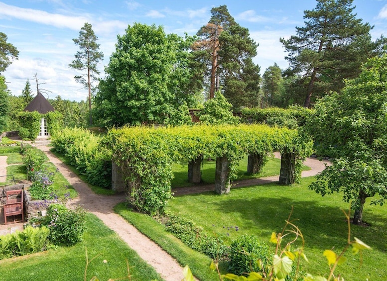 A well-maintained garden with a variety of trees, a hedge maze, and a gazebo. 4