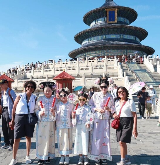 A group of people in traditional attire posing in front of the Temple of Heaven in Beijing. 2