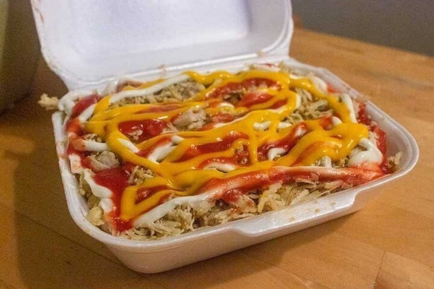 A takeout container with a meal, topped with ketchup and mustard. 3