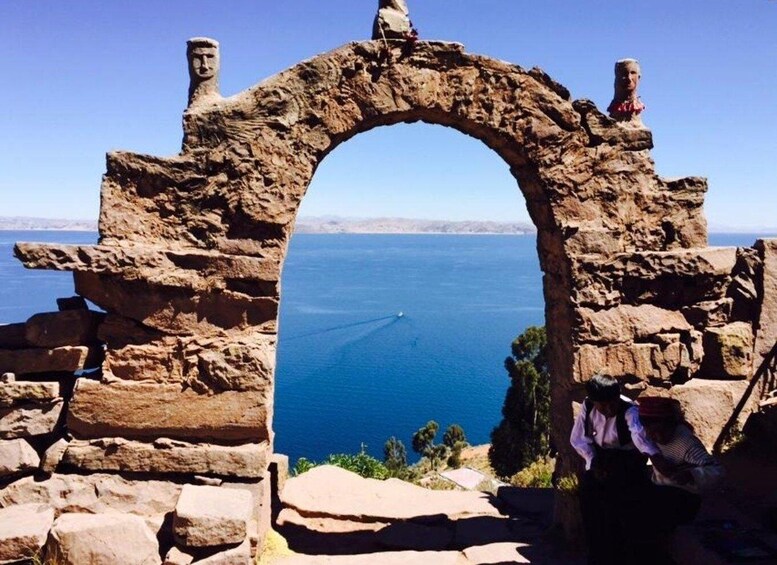 An ancient stone archway overlooking a body of water. 4
