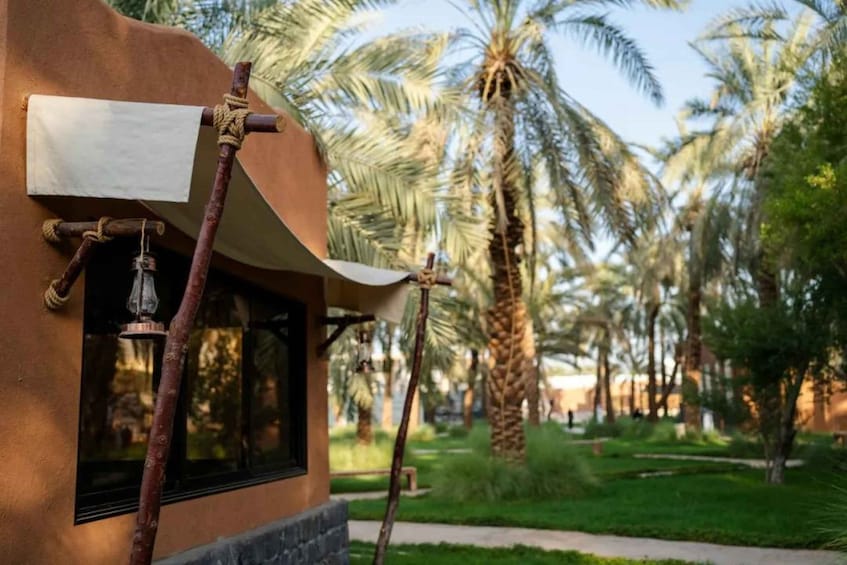 A building with a wooden structure, a bell, and a palm tree in the background. 3