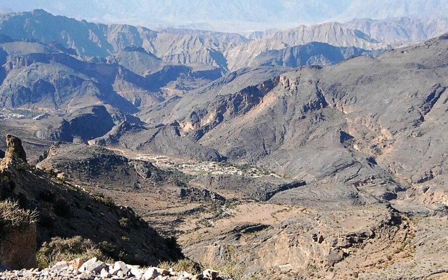 A rugged mountainous landscape with rocky terrain and sparse vegetation. 1