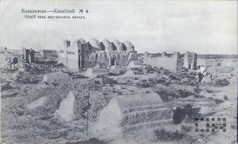 A historical site with ruins, including a large building with domed structures and a smaller building with a flat roof. 3