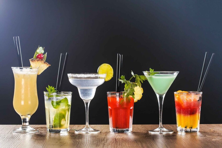 A variety of colorful cocktails on a wooden table. 4