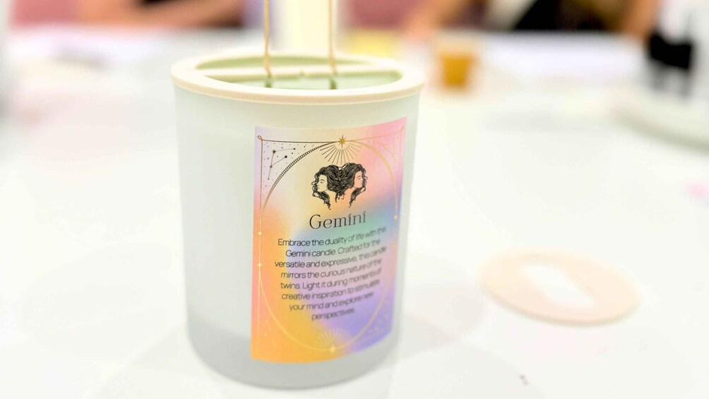A candle labeled 'Gemini' with a heart design and text describing its features. 5