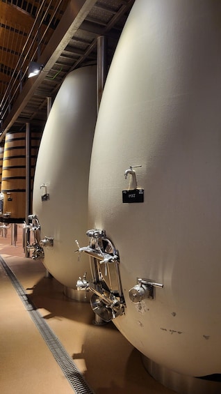 Large cylindrical tanks with taps and labels, likely part of a brewery or distillery. 2