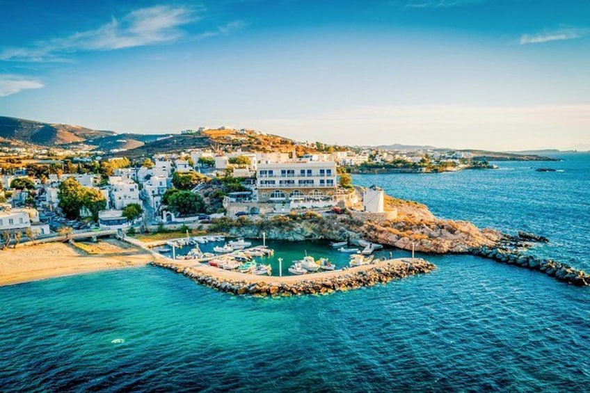 Un pueblo costero con edificios, un puerto deportivo y terreno rocoso. 1