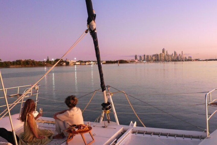 A couple on a boat with a city skyline in the background. 5