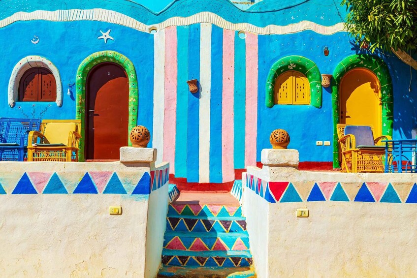 A colorful building with striped walls, arched doors, and geometric patterns. 3