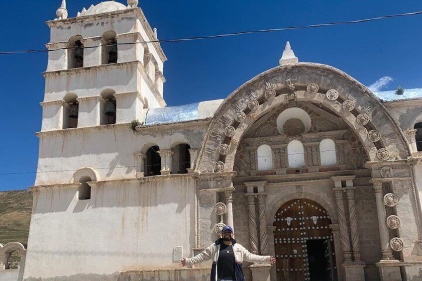 A white church with a bell tower and an arched entrance. 2