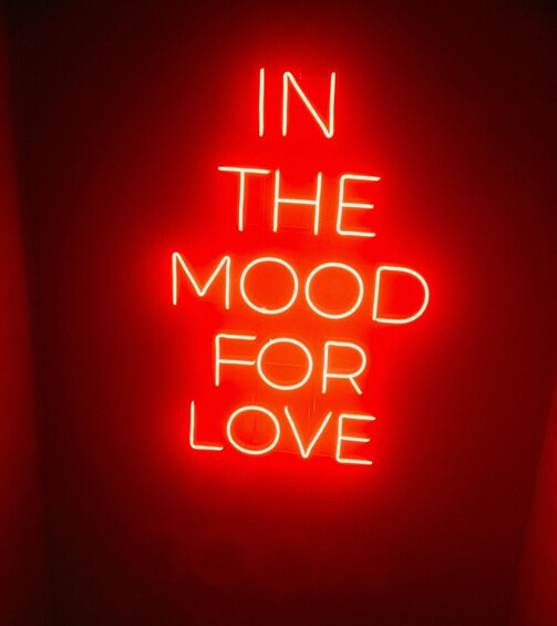 A neon sign with the text 'IN THE MOOD FOR LOVE' against a red background. 1