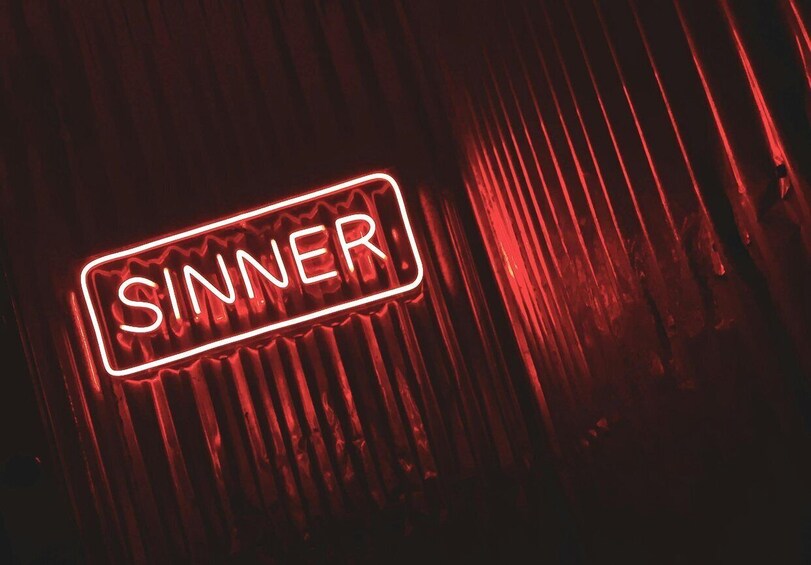 A neon sign with the word 'SINNER' in a rectangular shape. 5
