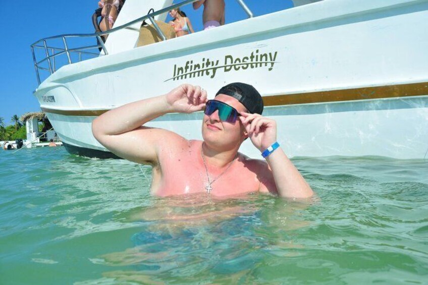 A person in the water near a boat named 'Infinity Destiny.' 4