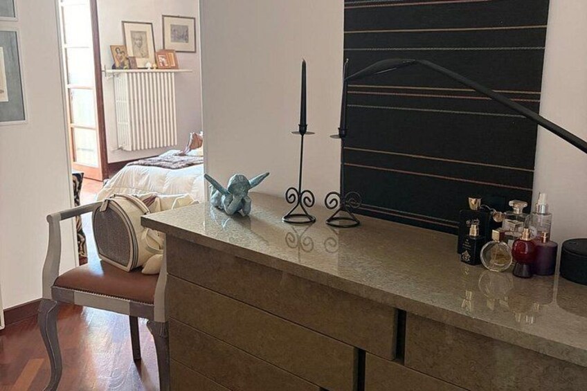 A kitchen counter with a decorative lamp, a chair, and various kitchen items. 5