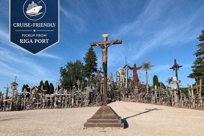 A cemetery with numerous crosses and a prominent crucifix in the center. 1