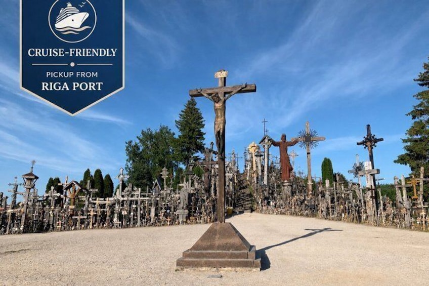 A cemetery with numerous crosses and a prominent crucifix in the center. 1