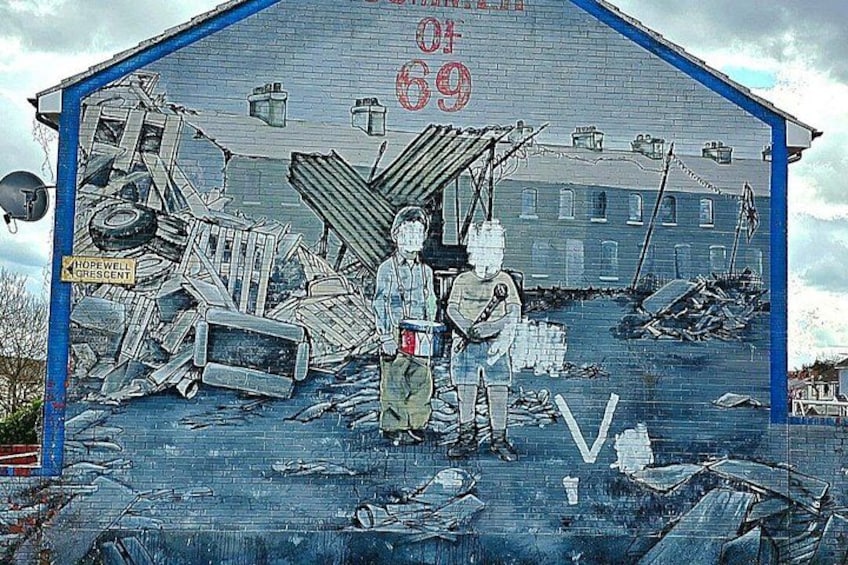 A mural with a building, debris, and two figures. 4