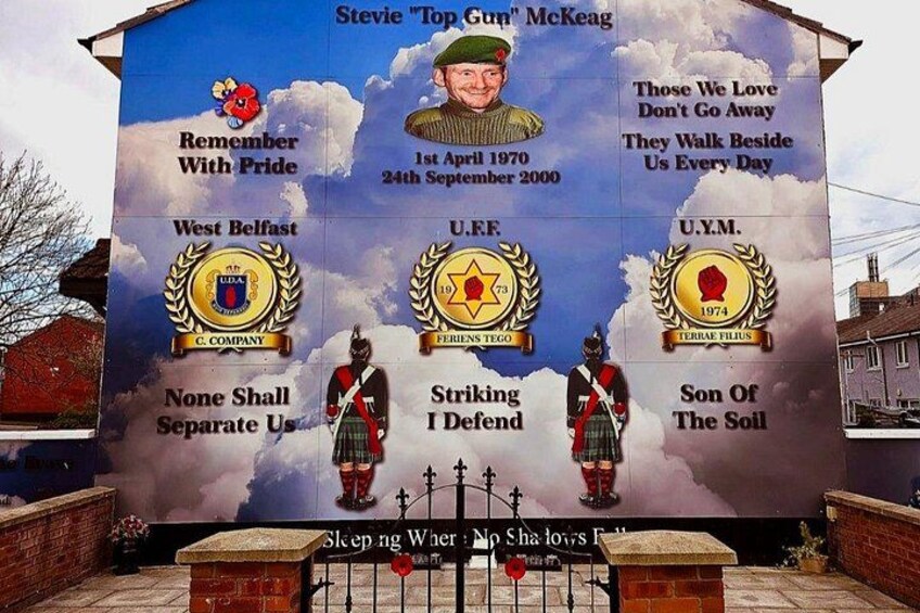 A memorial wall with portraits and text. 5