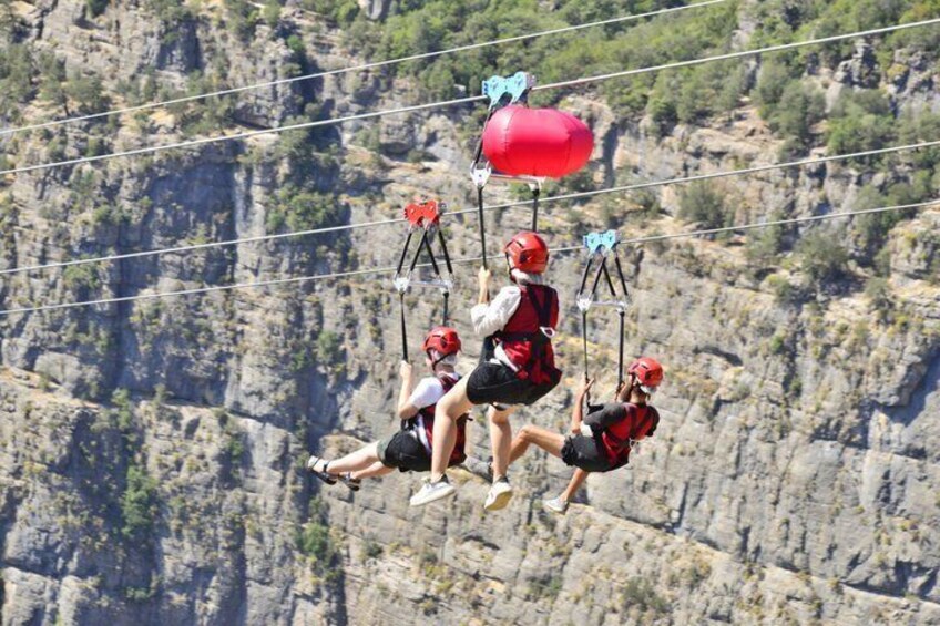 People bungee jumping from a cliff with a rocky landscape in the background. 4