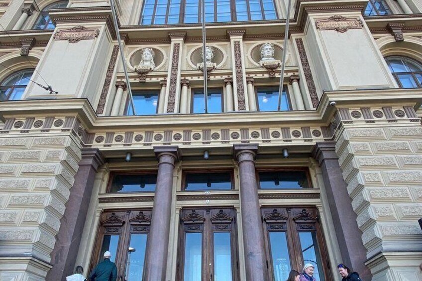 A classical building with ornate columns and decorative moldings. 1