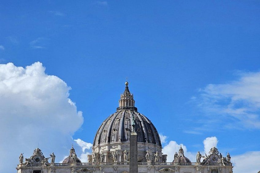 A large domed building with statues and intricate architectural details. 2