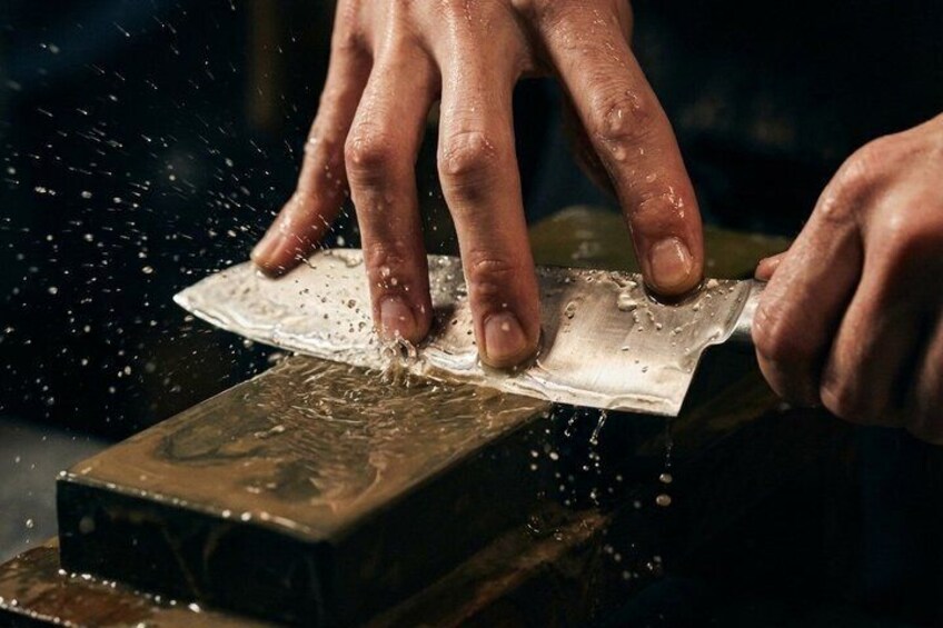Hands sanding a wooden block. 5