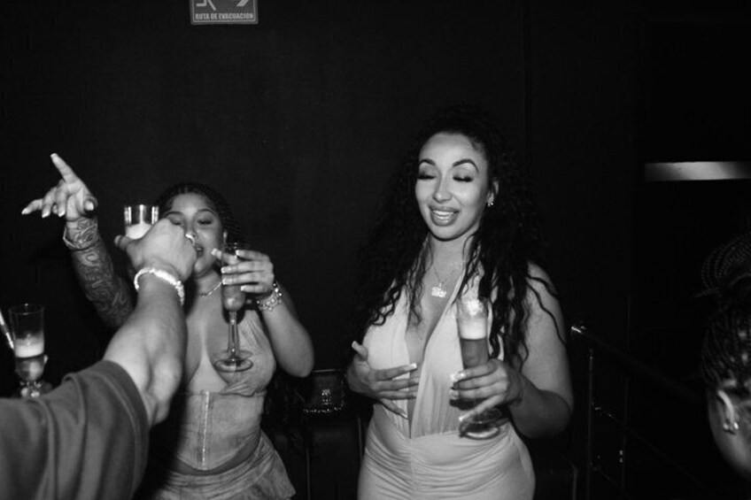 A group of people holding drinks, likely at a social event. 2
