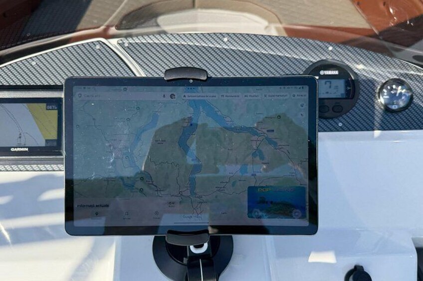 A Garmin device mounted on a boat, displaying a map. 2