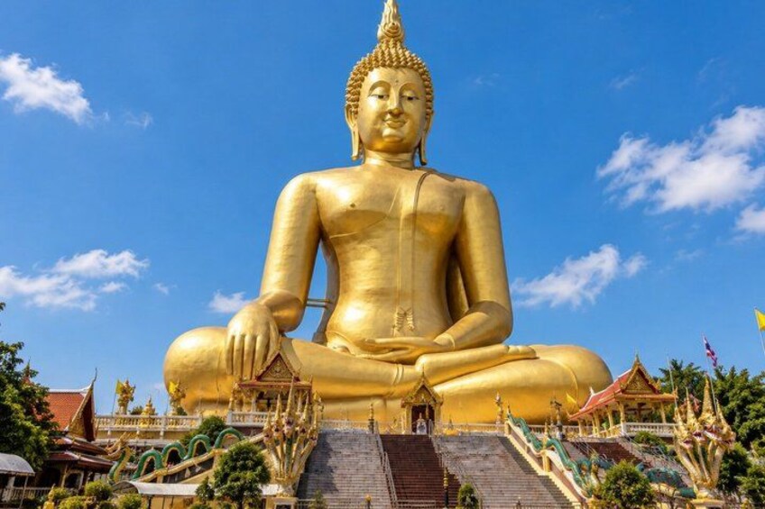 A large golden Buddha statue seated in a meditative pose, surrounded by a temple complex with traditional architecture. 4