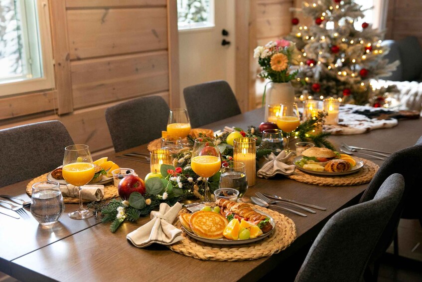 A festive breakfast setting with a Christmas tree in the background. 2