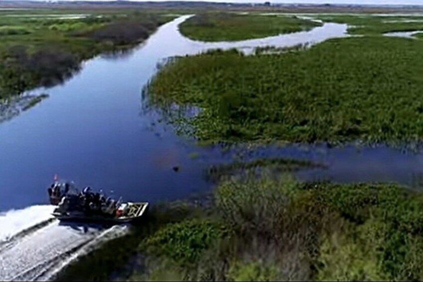 A river with a boat carrying people. 1