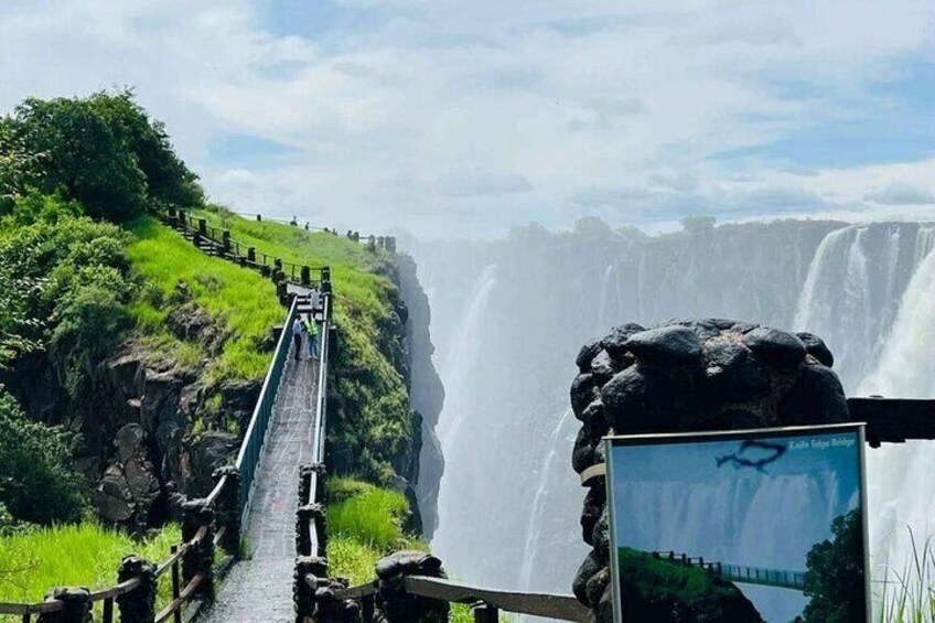 Una vista panorámica de una cascada, una plataforma de observación y un cartel con la ubicación. 2