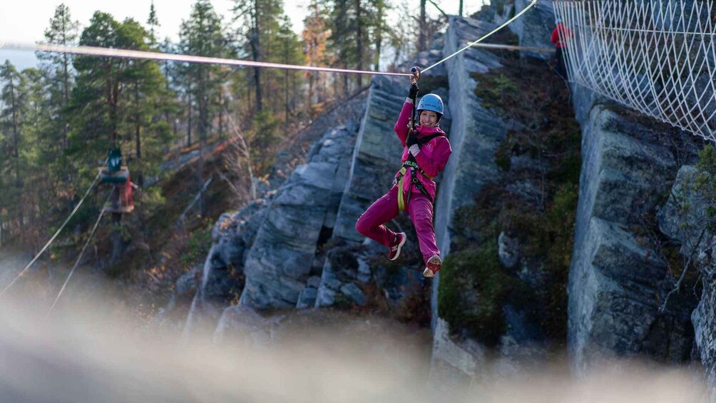 A person rappelling down a rocky cliff. 4