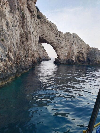 A natural rock arch over a body of water. 4