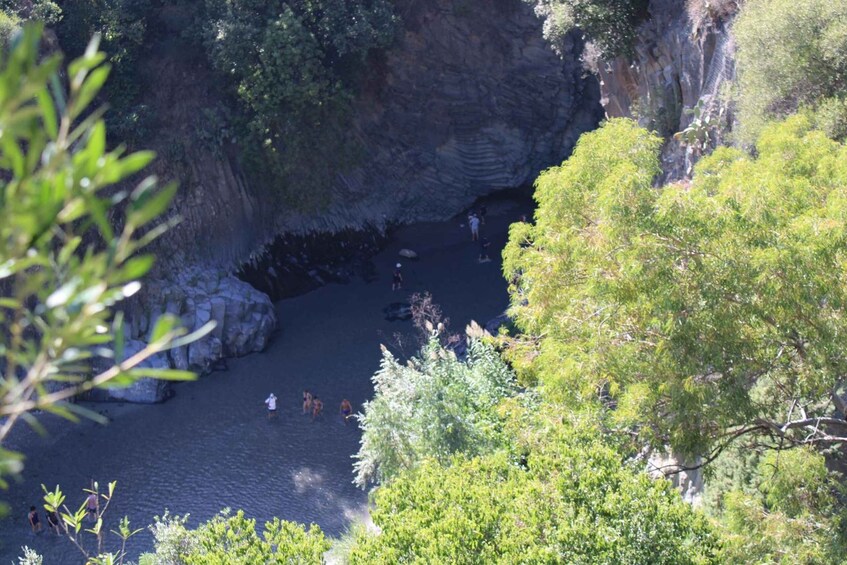 A river flowing through a rocky canyon surrounded by dense green foliage. 3