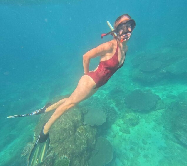 A person snorkeling underwater. 5
