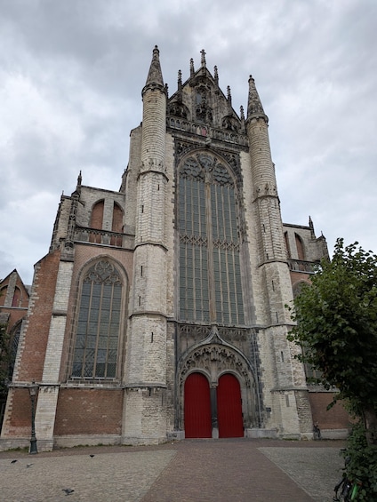A Gothic-style church with a large central window and red doors. 5