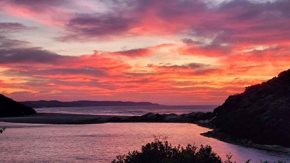A sunset over a river with hills on either side. 5