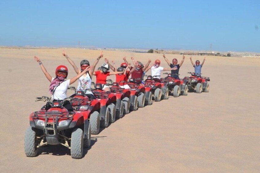 A group of people on ATVs in a desert landscape. 3